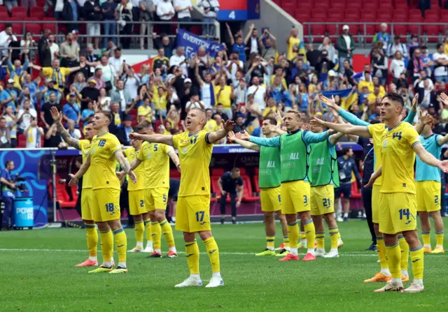 Ukraine players clap with fans