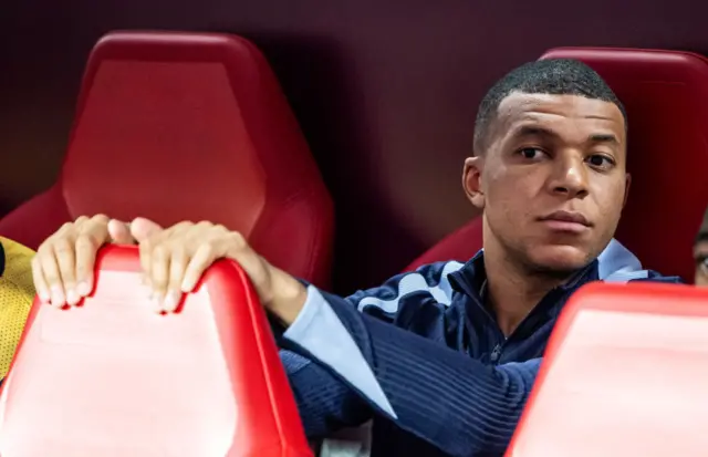 Kylian Mbappe watching on from the bench