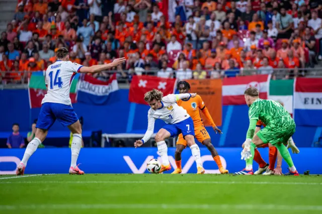 Antoine Griezmann stumbling on the ball