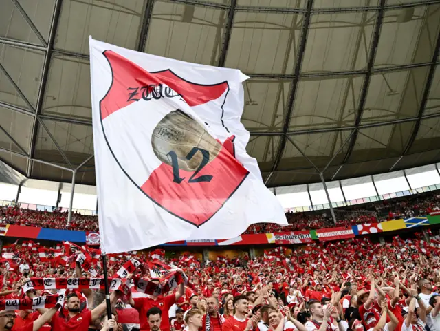 Austria fans hold a sign of supoort for their team