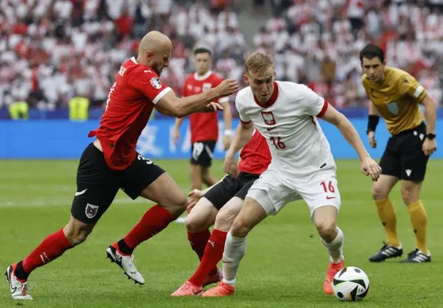 Gernot Trauner (L) of Austria and Adam Buksa of Poland in action