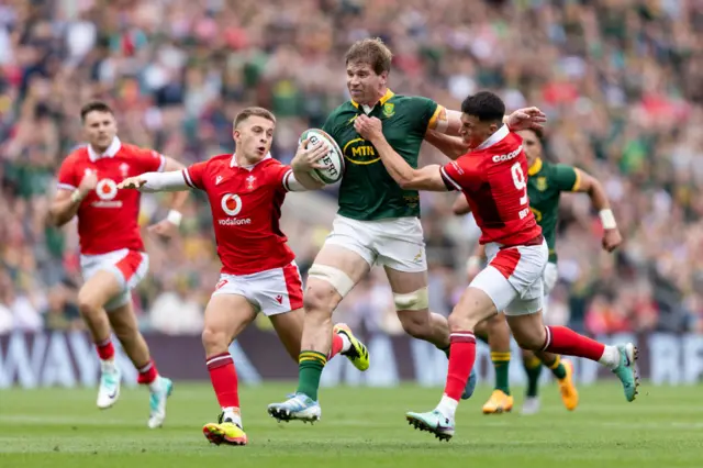 Cameron Winnett and Ellis Bevan attempt to bring down a charging Evan Roos