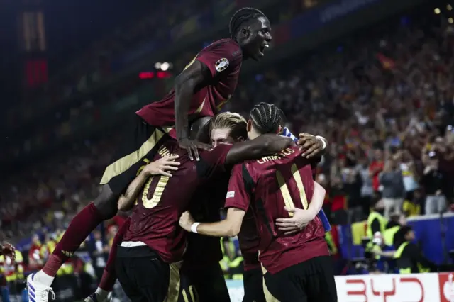 Belgium players mob de bruyne after he scores the second goal