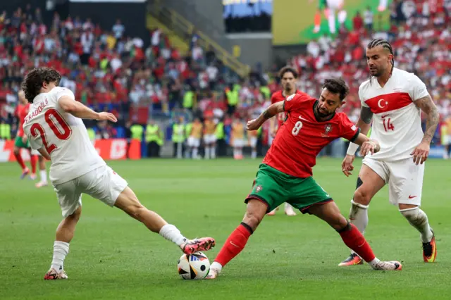 Fernandes is surrounded by Turkey players