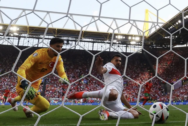 Turkey's Samet Akaydin scores Portugal second with an own goal as Zeki Celik and Altay Bayindir