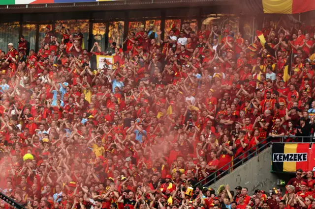 Belgium fans light flares in the stands