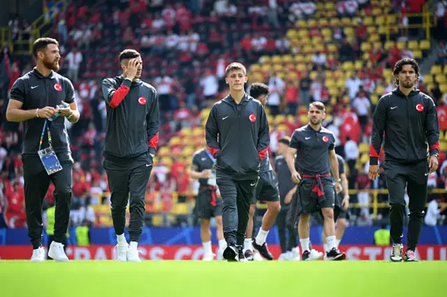 Arda Guler of Turkiye inspects the pitch with teammates