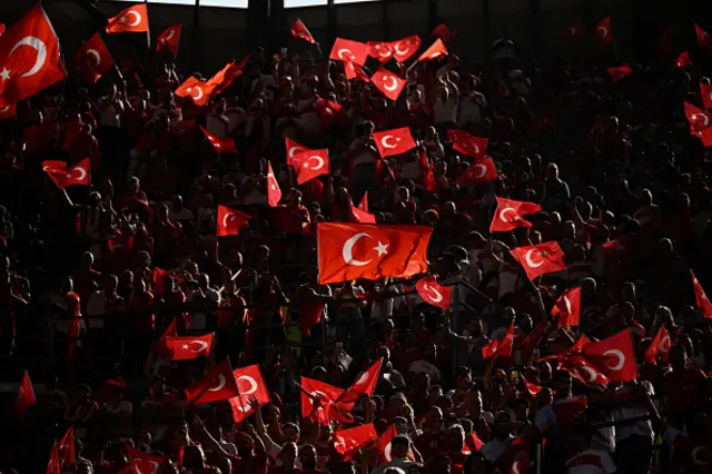 Turkey fans wave flags in the crowd