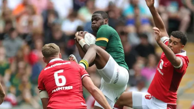 Alphele Fassi of South Africa is yellow carded for the challenge on Taine Plumtree