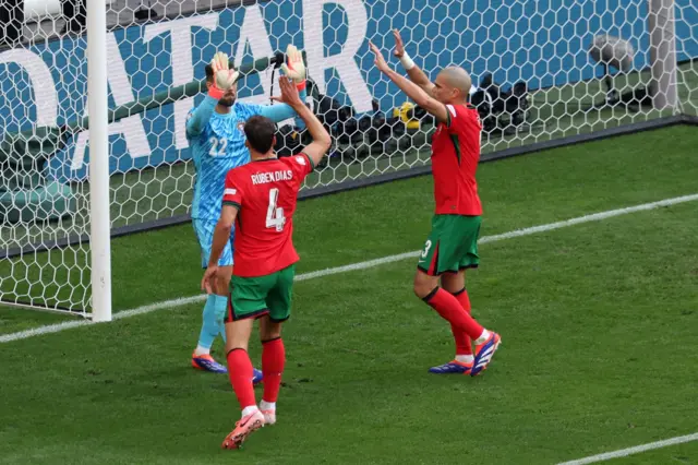 Portugal defenders high five their goalkeeper