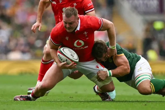Wales captain Dewi Lake is tackled by Kwagga Smith