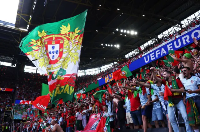 Portugal fans cheer and sing after their third goal