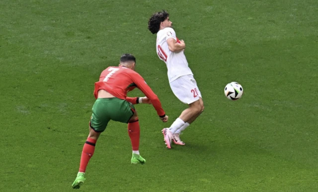 Portugal's Cristiano Ronaldo in action with Turkey's Ferdi Kadioglu