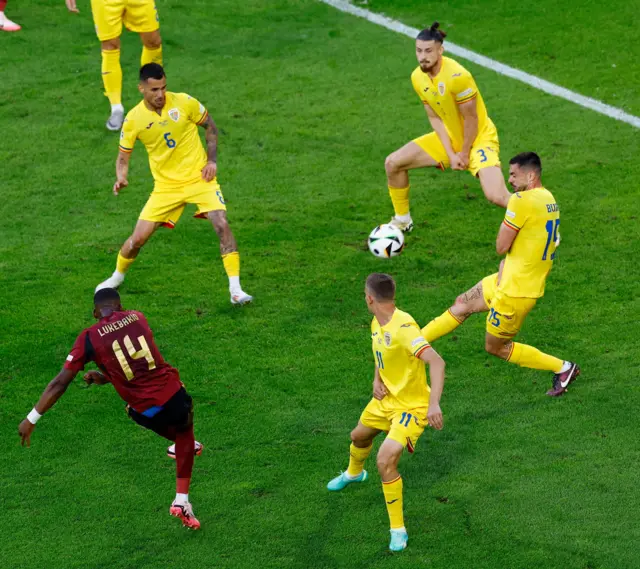 Lukebakio tries to shape a shot around a wall of defenders