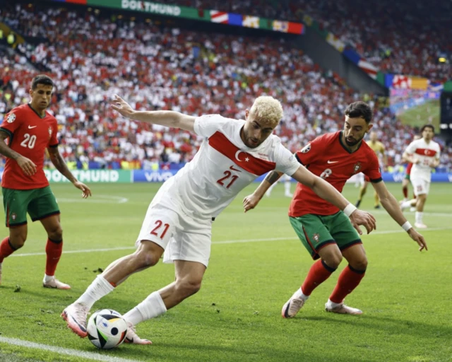 Turkey's Baris Alper Yilmaz in action with Portugal's Bruno Fernandes