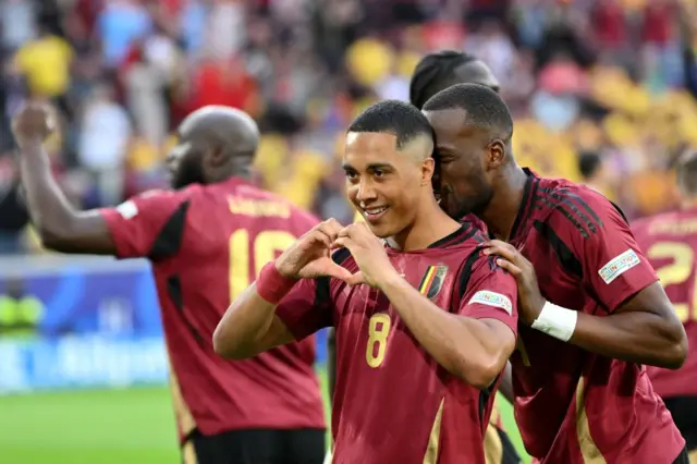 Tielemans celebrates his goal by making a heart sign with his hands