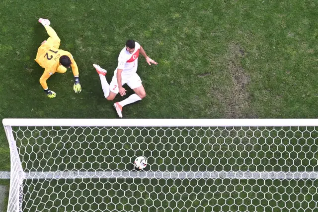 Turkey players try in vain to stop the ball from going over their goalline