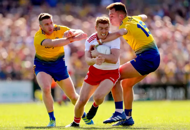 Peter Harte is tackled by Cathal Cregg and Enda Smith