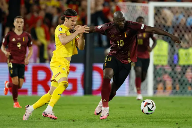 Lukaku holds off Hagi as he breaks upfield