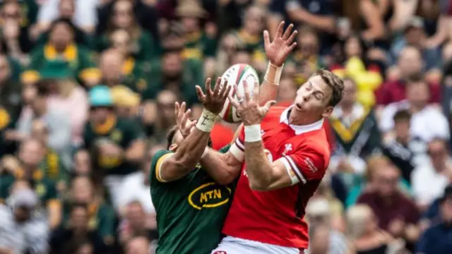 Liam Williams of Wales competing in the air with Jordan Hendrikse