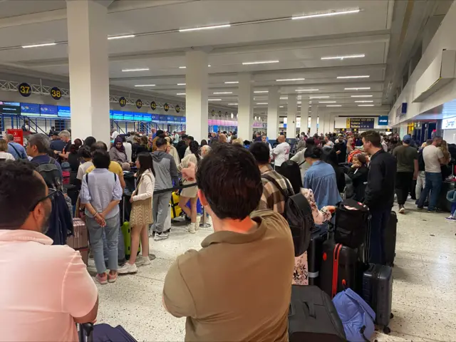 A long queue at Manchester Airport Terminal 1