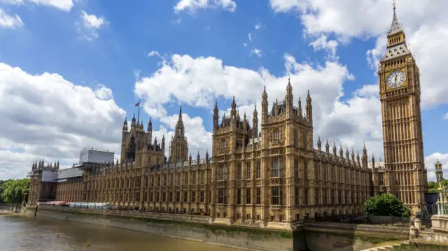 The Houses of Parliament are seen from an exterior view.