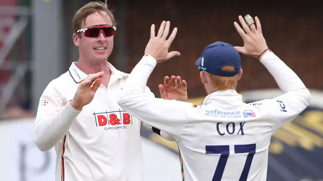 Simon Harmer celebrates a wicket with team-mate Jordan Cox