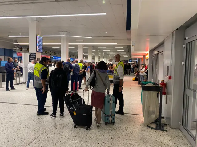 Staff speaking to passengers at Manchester Airport Terminal 1