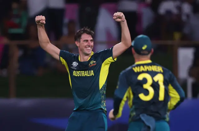 Pat Cummins celebrates taking a wicket against Afghanistan