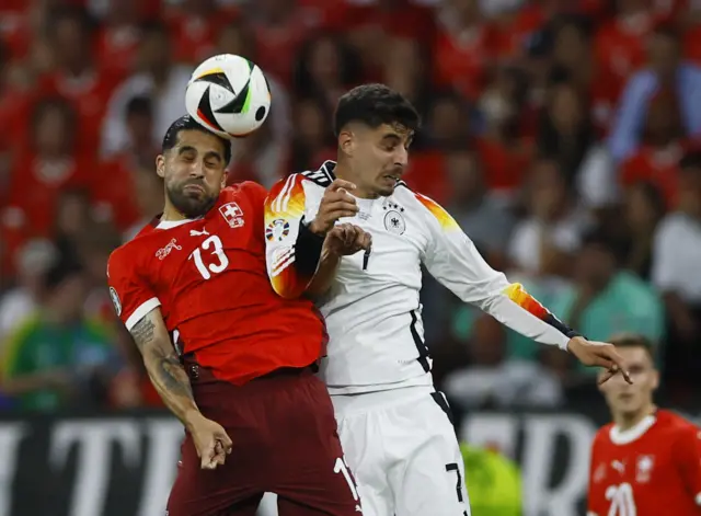 Havertz and Rodriguez jump for the ball