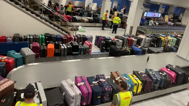 Luggage piled up at Manchester Airport