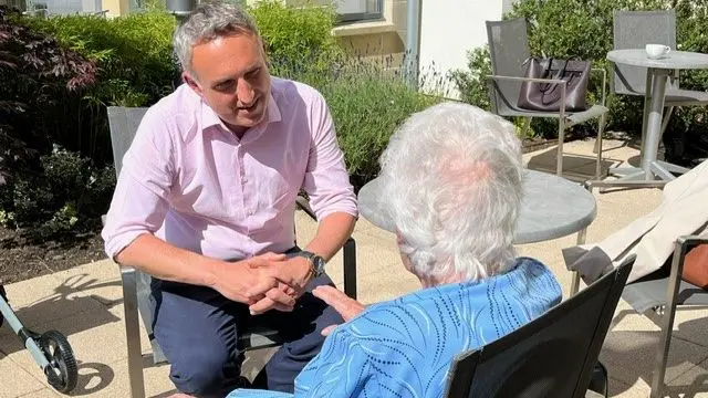 Scottish Lib Dem leader Scottish Lib Dems chats to tan elderly woman at a care home