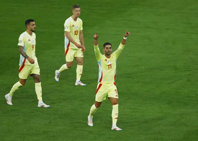 Spain's Ferran Torres celebrates scoring their first goal with Dani Olmo and Joselu