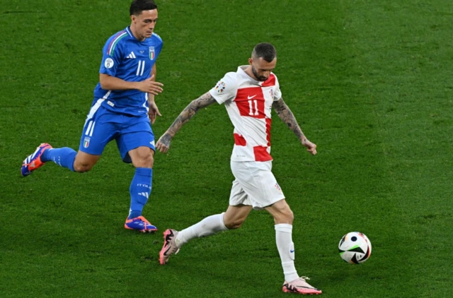 Croatia's Marcelo Brozovic in action with Italy's Giacomo Raspadori