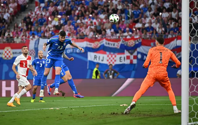 lessandro Bastoni of Italy makes a headed attempt on goal as Dominik Livakovic