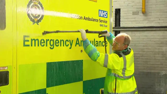 Ed Davey cleaning an ambulance