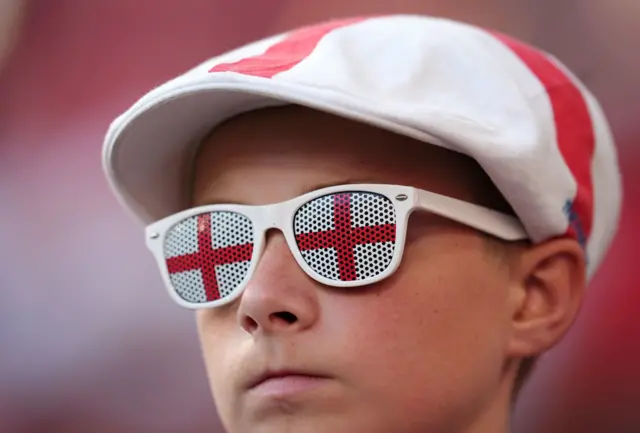 Young fan with a St George flat cap and glasses