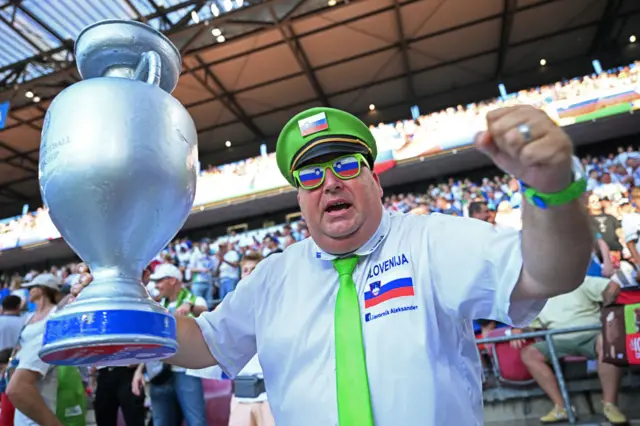 Fan holds aloft inflatable trophy