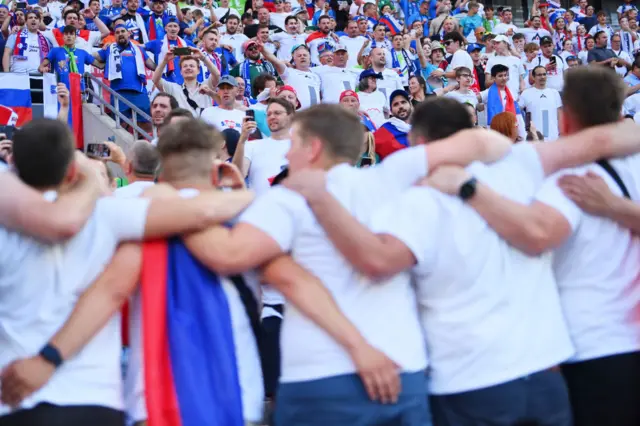 Slovenia fans gather and chant