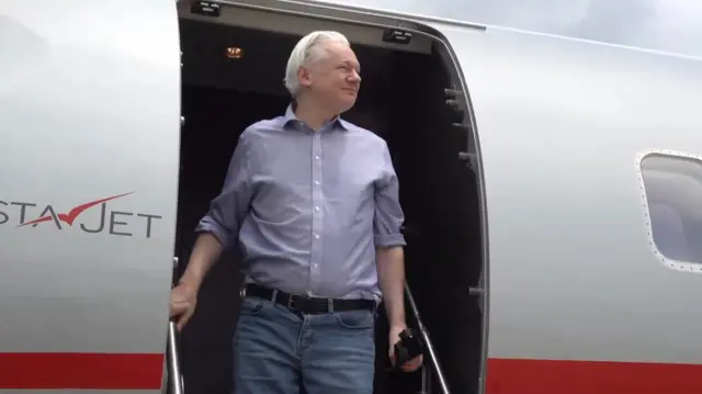 Man walking out of plane, looking out