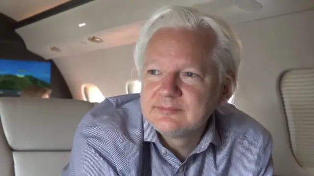 Picture of man looking out of plane window