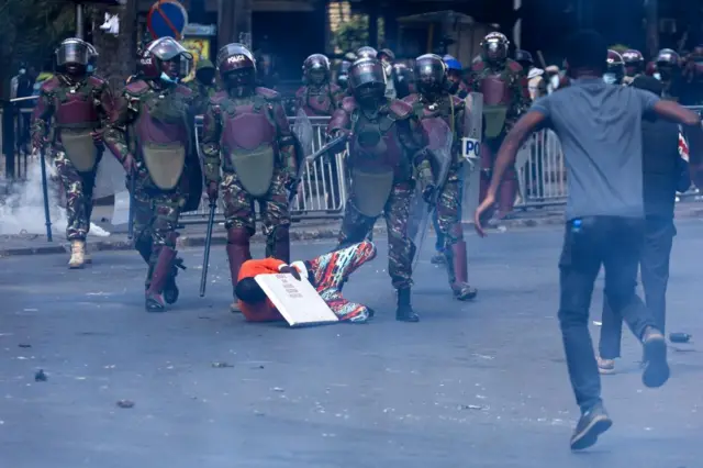 Anti-riot police surround a demonstrator