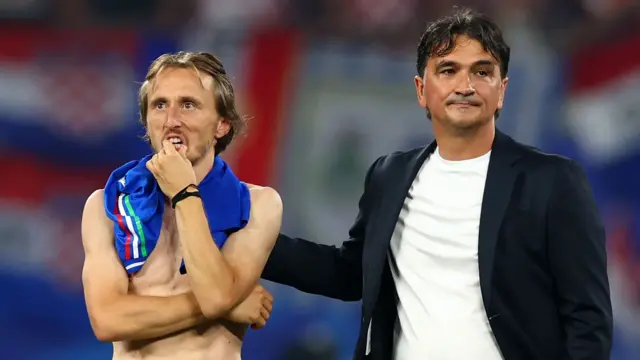 Luka Modric of Croatia reacts at full-time next to coach Zlatko Dalic