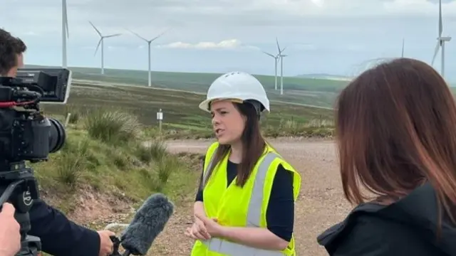 Kate Forbes speaks to media from a wind farm in East Lothian