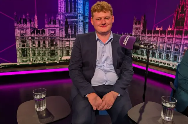 Conservative candidate Luke Allan Holmes sat in the studio with a microphone in front of him