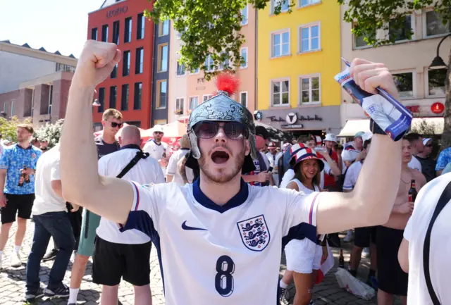 England fan wearing a knight helmet and a team shirt