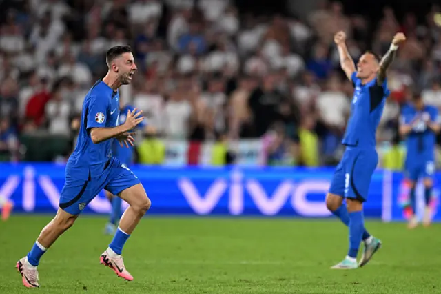 Andraz Sporar (L) celebrates qualifying for the knock-out stages on the pitch