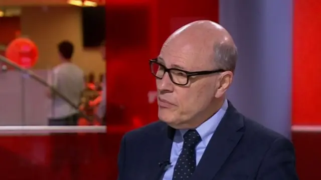 Joshua Rozenberg - who is wearing black framed glasses and a suit and tie - on the BBC News channel