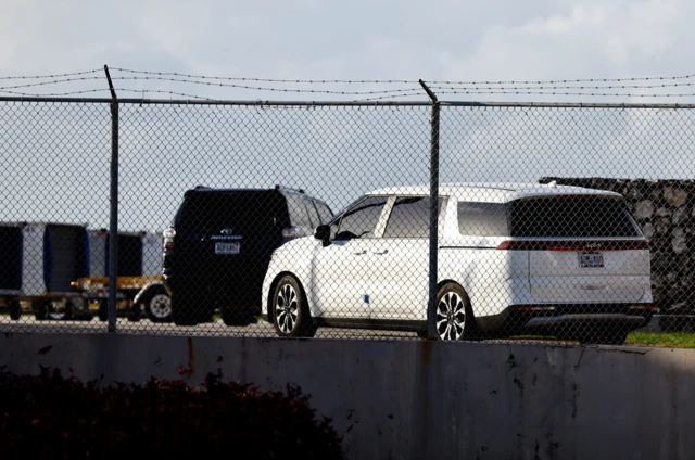 A motorcade leaves Saipan airport