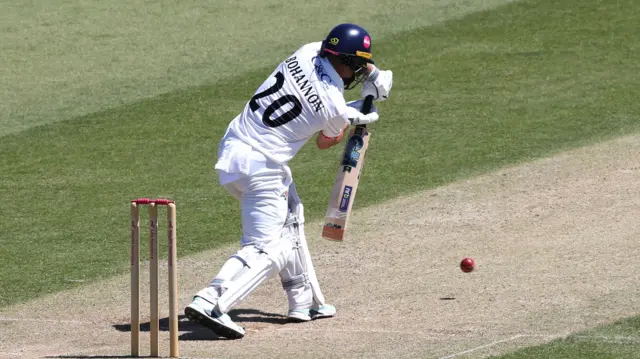 Josh Bohannon batting for Lancashire, defending the ball